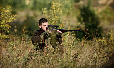 Man wear camouflage clothes nature background. Hunting permit. Hunter hold rifle. Hunting is brutal...