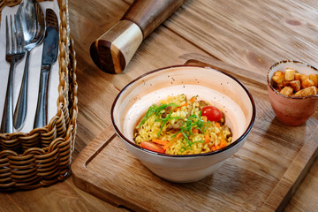 pilaf with vegetables served on a wooden table