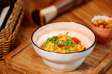 pilaf with vegetables served on a wooden table