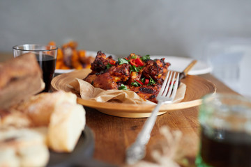 Low angle view of table served with traditional British Sunday roast dinner, featuring roasted chicken, squash and sweet potatoes