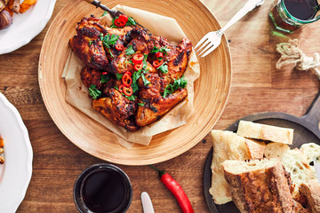 Overhead view of table served with traditional British Sunday roast dinner, featuring roasted chicken, squash and sweet potatoes