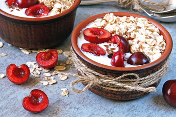 Breakfast oatmeal with yogurt and sweet cherries. Kefir and oatmeal. Probiotics. Fermented dairy products.