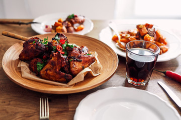View of table served with traditional British Sunday roast dinner, featuring roasted chicken, squash and sweet potatoes