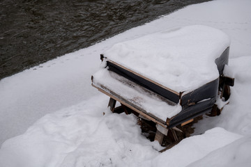 Abandoned piano covered by snow