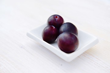 fresh plums in a bowl