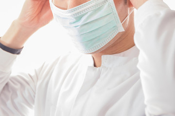 Fototapeta premium Doctor wearing white protective mask in white background