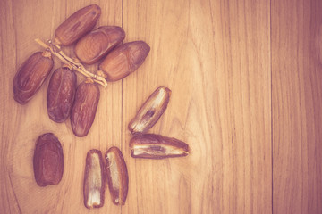 Close up fruits of date palm on wood background,fresh date-palm and dry date-palm on rustic wooden 