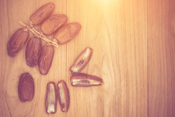 Close up fruits of date palm on wood background,fresh date-palm and dry date-palm on rustic wooden 