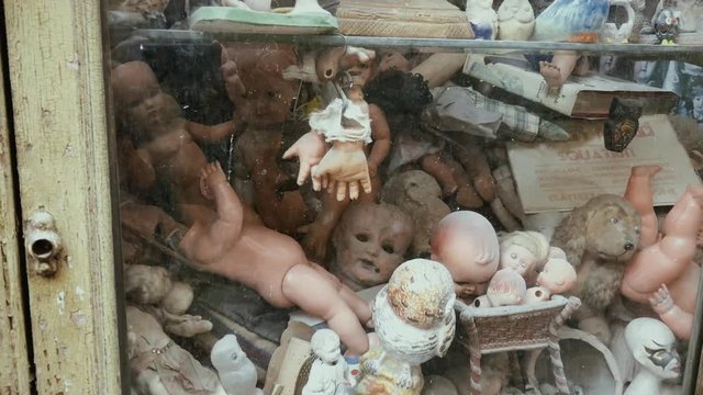 Spooky antiquity dolls shop window