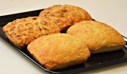 wheat buns with cheese on a black board