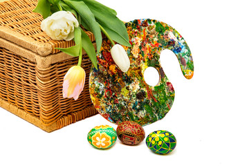 Easter eggs and tulips. Easter eggs with tulips on a white background, easter holiday concept. Palette with colorful paints