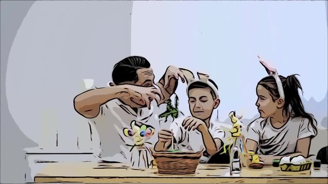 Father is with his kids: daughter and son, who are wearing bunny ears, sitting at the holiday table. Father is trying to scare kindly his children. Father steals bunny ears in his daughter and showing