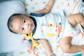 Infant baby boy chewing on teething with rubber