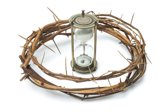 Thorn crown and hour glass sand timer on white background