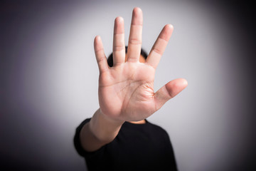 Hand of young man implying NO sign, rejecting expression or prevention