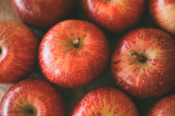 Red fresh apples as background. Close up view of heap of delicious apples as texture and background. 
