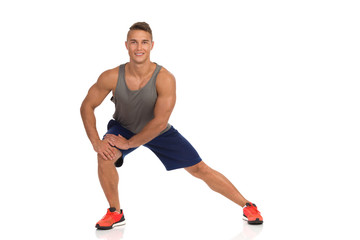 Obraz premium Young Man Stands Apart, Warms Up And Stretches