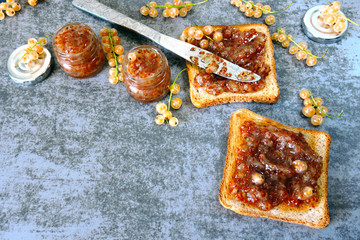 Toast with homemade currant jam. Freshly made jam from white currant. White currant. Useful sweets. Delicious croutons with white-currant jam.