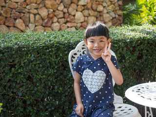 Happy Asian little girl in garden