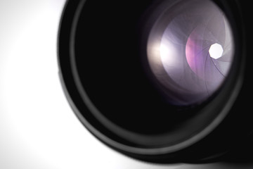 closing aperture of camera lens with lense reflections on the white background