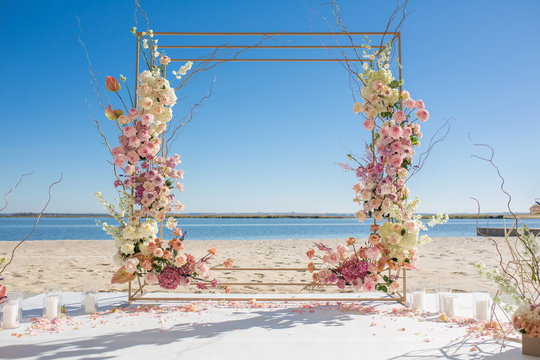 Event decoration. Wedding chuppa at riverside decorated with fresh flowers. Florist workflow