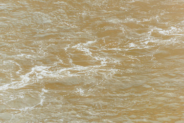 The footprint of the motor boat on the water surface. Water transport. Texture of dirty water.