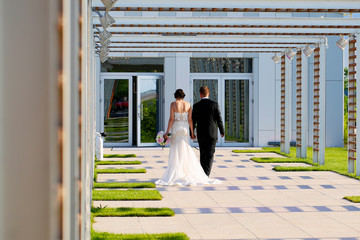 Wedding couple walking to the reception room