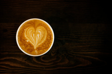 Cup of cappuccino coffee with heart shape latte art on old wood table Background, Latte coffee on old wooden Background table