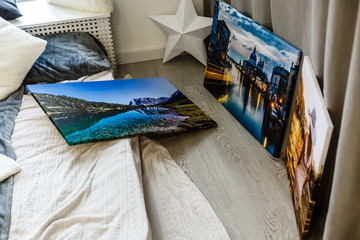 wall art canvas in three parts. Sofa, lamp, plant and table in room interior.