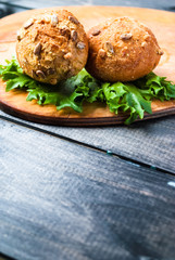Burger with lettuce on rustic wooden board