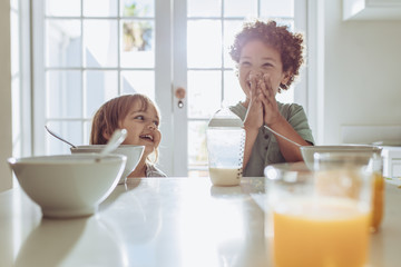 Smiling kids at the breakfast table