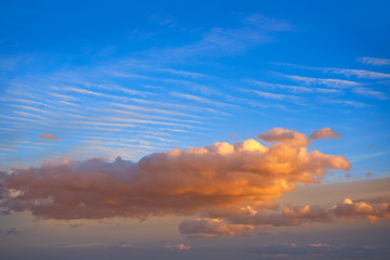 Sunset clouds in orange and blue sky