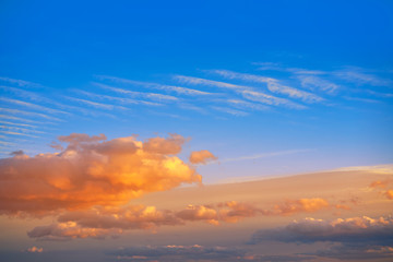 Sunset clouds in orange and blue sky