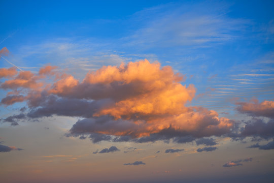 Sunset clouds in orange and blue sky © lunamarina