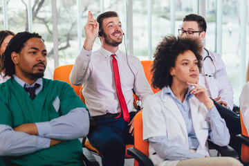 Group of happy doctors on seminar in lecture hall at hospital