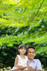 young father spending time with his daughter at park during weekend