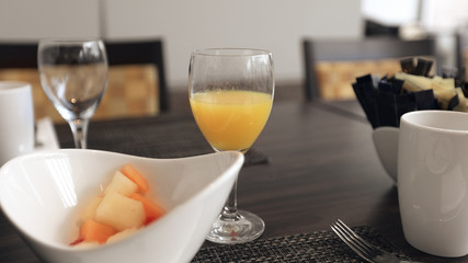 Fruits and orange juice on breakfast table