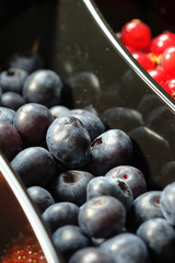 plastic containers box of berries, red currants and blueberries. Close up