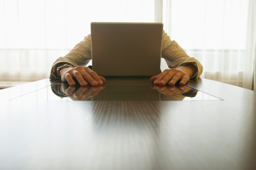 Businessman behind laptop
