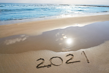 year 2021 numbers spell written on beach