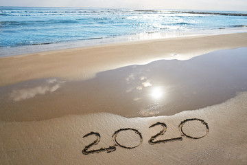 year 2020 numbers spell written on beach