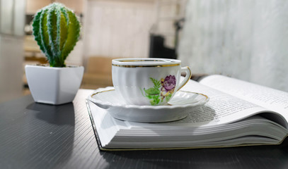cup of tea and flowers on wooden table