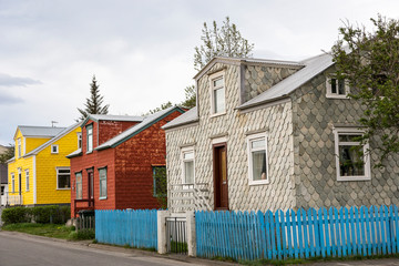 Pretty traditional colourful houses covered in stone tiles or corrugated iron in the old part of Akureyri, Iceland