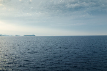 Seascape with sea horizon and almost clear deep blue sky 