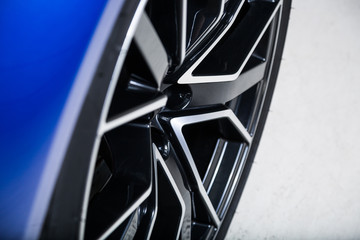 Diamond cut wheel of blue sports car