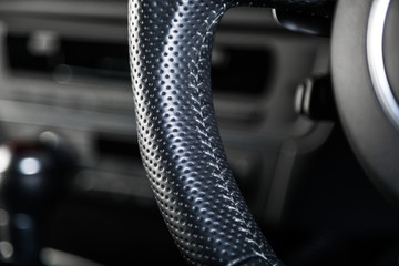 Close up of black steering wheel