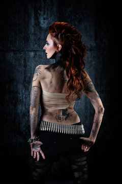 Young tattooed woman, from behind