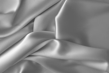 Fototapeta na wymiar Rippled white silk fabric satin cloth waves background