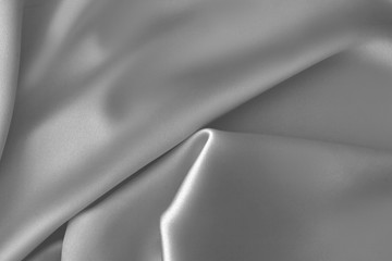 Fototapeta na wymiar Rippled white silk fabric satin cloth waves background