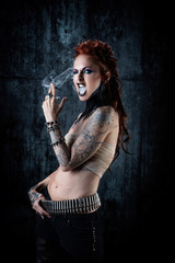Young tattooed woman, one-eyed, a cigarette in her hand